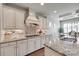 Modern kitchen with granite counters, a mosaic backsplash, and white cabinetry at 525 Chase Prairie Ln, Waxhaw, NC 28173