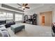 Spacious living room featuring a ceiling fan, a leather couch, and built-in shelving at 525 Chase Prairie Ln, Waxhaw, NC 28173