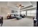 A well-lit living room boasts a ceiling fan and a comfortable-looking leather couch at 525 Chase Prairie Ln, Waxhaw, NC 28173