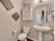 Stylish powder room featuring a pedestal sink and unique wall decor at 525 Chase Prairie Ln, Waxhaw, NC 28173