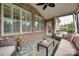 Stylish screened porch featuring brick, large windows, ceiling fan, and comfortable seating area at 525 Chase Prairie Ln, Waxhaw, NC 28173