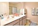 Bathroom featuring double sinks with gray cabinets, a shower/tub combo with sliding glass doors, and neutral decor at 525 San Marco Dr, Gastonia, NC 28056
