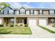 Charming townhouse exterior boasts a well-manicured lawn, brick accents and attached garages at 525 San Marco Dr, Gastonia, NC 28056