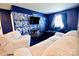 Living room with a decorative wall, modern TV set up, plushy white furniture, and a contemporary design at 525 San Marco Dr, Gastonia, NC 28056