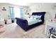 Chic main bedroom with a striking blue velvet bed and stylish decor at 525 San Marco Dr, Gastonia, NC 28056