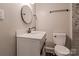 Bathroom with toilet, and vanity with vessel sink, mirror, and stylish black hardware at 530 W Franklin St, Salisbury, NC 28144