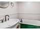 Bathroom featuring a pedestal sink and an antique claw foot tub with green exterior at 530 W Franklin St, Salisbury, NC 28144