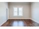 Empty bedroom featuring hardwood floors and large windows at 530 W Franklin St, Salisbury, NC 28144