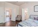 Bedroom with hardwood floors and doors leading to hallway and an ensuite bathroom at 530 W Franklin St, Salisbury, NC 28144