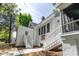 Charming white home featuring dual staircases with a colorful quilt accent and landscaped yard at 530 W Franklin St, Salisbury, NC 28144