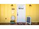 Charming yellow home featuring a welcoming white front door and decorative accents on the covered porch at 530 W Franklin St, Salisbury, NC 28144