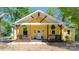 Inviting yellow home featuring a charming porch and crisp white trim details at 530 W Franklin St, Salisbury, NC 28144
