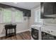 Laundry room with utility sink, washer, dryer, and ample natural light at 530 W Franklin St, Salisbury, NC 28144