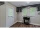 Laundry room with utility sink, door to outside, and view of yard at 530 W Franklin St, Salisbury, NC 28144