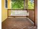 Relax on the porch with a white wooden swing and a view of the green trees at 530 W Franklin St, Salisbury, NC 28144