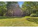 Large level backyard surrounded by mature trees offers a peaceful and private outdoor space at 5317 Friendly Baptist Ch Rd, Indian Trail, NC 28079