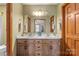 Bathroom featuring a double vanity with warm wood cabinetry and ample lighting at 5317 Friendly Baptist Ch Rd, Indian Trail, NC 28079