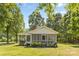 Charming cottage with screened porch and manicured lawn provides a welcoming curb appeal at 5317 Friendly Baptist Ch Rd, Indian Trail, NC 28079