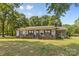 Charming one-story home with a welcoming front porch and well-maintained lawn surrounded by mature trees at 5317 Friendly Baptist Ch Rd, Indian Trail, NC 28079