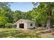 Detached garage offers space for parking and projects on a sunny day at 5317 Friendly Baptist Ch Rd, Indian Trail, NC 28079