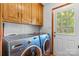 Bright laundry room with a Samsung washer and dryer and plenty of overhead cabinet space at 5317 Friendly Baptist Ch Rd, Indian Trail, NC 28079