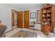 Room features multiple doorways, carpet, a window, chair, and wooden decorative cabinet at 5317 Friendly Baptist Ch Rd, Indian Trail, NC 28079