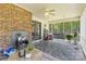 Relax on this covered porch with brick fireplace and a swinging chair overlooking the backyard at 5317 Friendly Baptist Ch Rd, Indian Trail, NC 28079