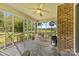 Covered porch with brick accent wall, ceiling fan, stone floor, and relaxing backyard views at 5317 Friendly Baptist Ch Rd, Indian Trail, NC 28079