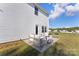 Charming backyard with patio seating, a grill, manicured lawn and white siding, perfect for relaxation and outdoor entertaining at 548 Dutch White Dr, Clover, SC 29710
