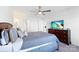 Well-lit bedroom with a queen-sized bed, a ceiling fan, and a dresser with a television at 548 Dutch White Dr, Clover, SC 29710