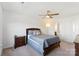 Bedroom with a dark wood bed frame, neutral carpet, and ceiling fan at 548 Dutch White Dr, Clover, SC 29710
