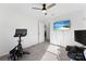 Spacious bedroom with exercise bike, ceiling fan, wall-mounted TV, offering options for fitness and entertainment at 548 Dutch White Dr, Clover, SC 29710