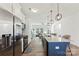 Modern kitchen features a large island, stainless steel appliances, and an open layout into the living room at 548 Dutch White Dr, Clover, SC 29710
