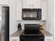 Close up of the kitchen featuring modern appliances and granite countertops with a white backsplash at 548 Dutch White Dr, Clover, SC 29710