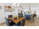 Bright kitchen flows into a dining area with a wood table and seating for four at 548 Dutch White Dr, Clover, SC 29710