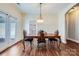 Dining room features wood floors and elegant table with seating for four at 5604 Bradford Lake Ln, Charlotte, NC 28269