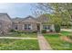 Charming single-story home featuring a brick facade, well-maintained lawn, and inviting walkway at 5604 Bradford Lake Ln, Charlotte, NC 28269