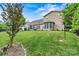 Spacious backyard with a well-manicured lawn and lush landscaping at 5722 Kirkwynd Commons Dr, Charlotte, NC 28278