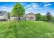 Lush green backyard with a well-manicured lawn and beautiful landscaping at 5722 Kirkwynd Commons Dr, Charlotte, NC 28278