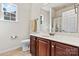 Bright bathroom with a white toilet and sink and an appealing vanity with dark wood cabinets at 5722 Kirkwynd Commons Dr, Charlotte, NC 28278