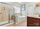 Bathroom features include a glass-enclosed shower, separate tub, and vanity with sink at 5722 Kirkwynd Commons Dr, Charlotte, NC 28278