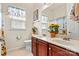 Bright bathroom with double sinks, decorative accents, and a large window at 5722 Kirkwynd Commons Dr, Charlotte, NC 28278