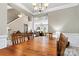 Formal dining room featuring hardwood floors and an elegant chandelier at 5722 Kirkwynd Commons Dr, Charlotte, NC 28278