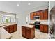 Well-lit kitchen with stainless steel appliances, granite countertops, and a center island at 5722 Kirkwynd Commons Dr, Charlotte, NC 28278