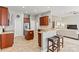 Open kitchen featuring stainless steel appliances, breakfast bar and ceramic tile flooring at 5722 Kirkwynd Commons Dr, Charlotte, NC 28278