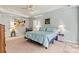 Spacious main bedroom features a ceiling fan, neutral color palette, and stylish decor at 5722 Kirkwynd Commons Dr, Charlotte, NC 28278