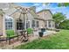 Charming patio with outdoor seating, an umbrella, and a cozy fire pit for entertaining at 5722 Kirkwynd Commons Dr, Charlotte, NC 28278