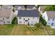 Aerial view of home with a spacious backyard, patio set, and lush green grass at 5803 Lindley Crescent Dr, Indian Trail, NC 28079