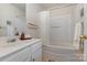 Bright bathroom featuring a shower-tub combo, white vanity, and coordinated decor at 5803 Lindley Crescent Dr, Indian Trail, NC 28079
