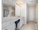 This bathroom has light tile, a double sink with marble counters, a large mirror, and makeup chair at 5803 Lindley Crescent Dr, Indian Trail, NC 28079